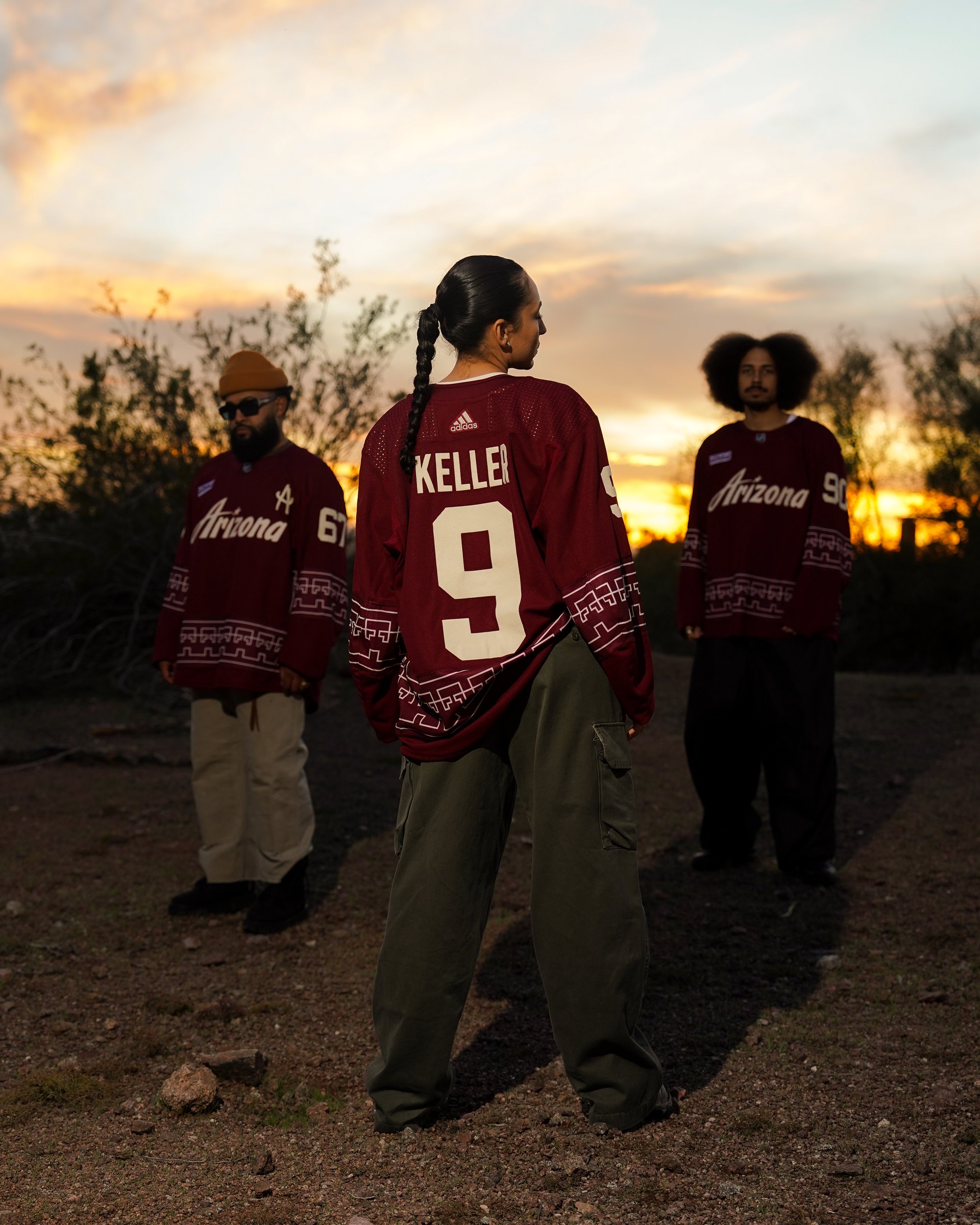Three people in Desert Night Arizona Coyotes jerseys at sunset in the desert